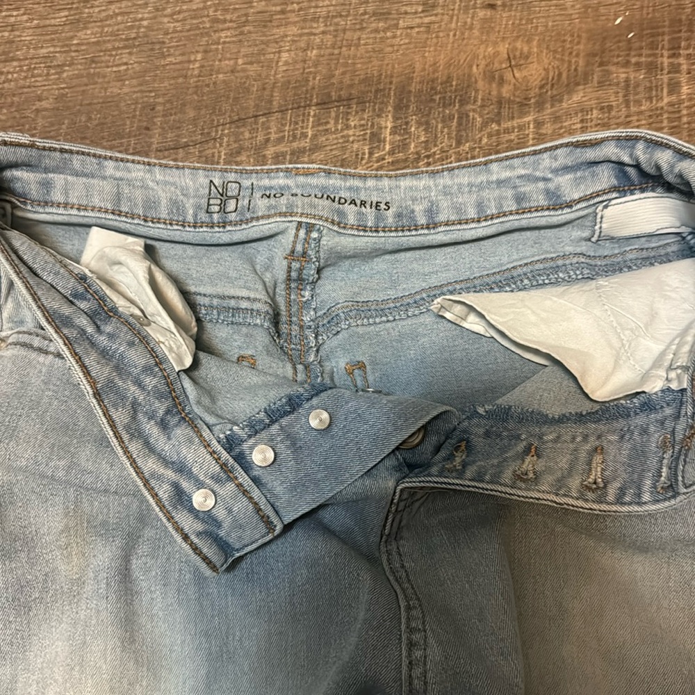 Light washed jeans holes at knees  baggy at bottom